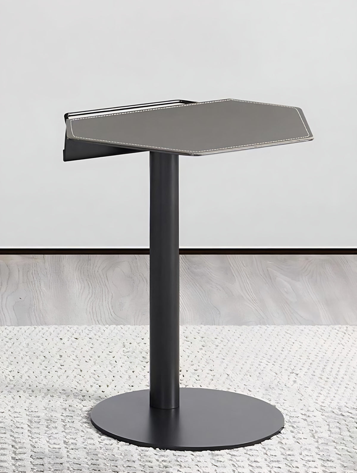 CHIC Geo side shelf in dark metal beside an upholstered sofa