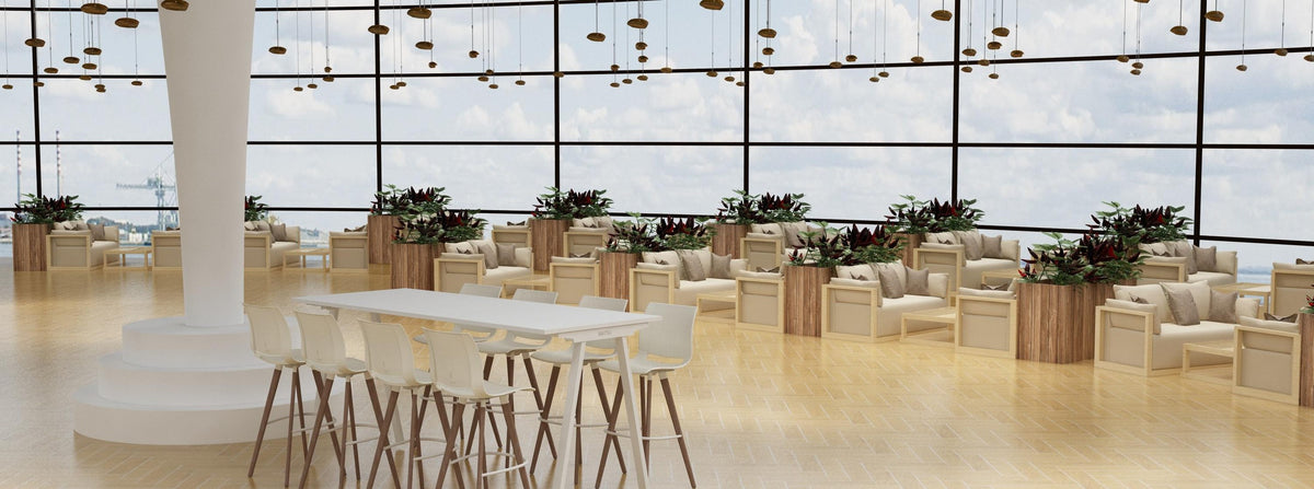 Long Cuka high tables with bar stools in an atrium