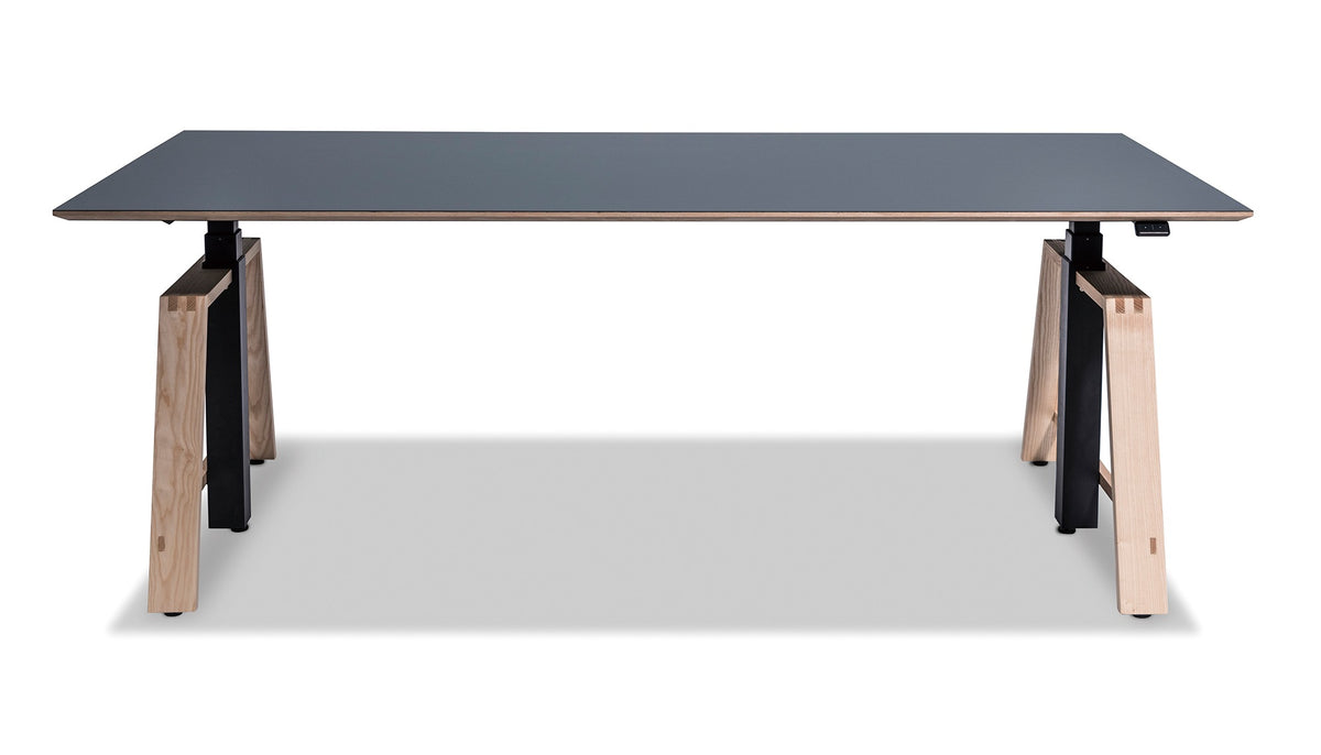 MATSU Motu height-adjustable desk with dark top and oak legs, studio shot