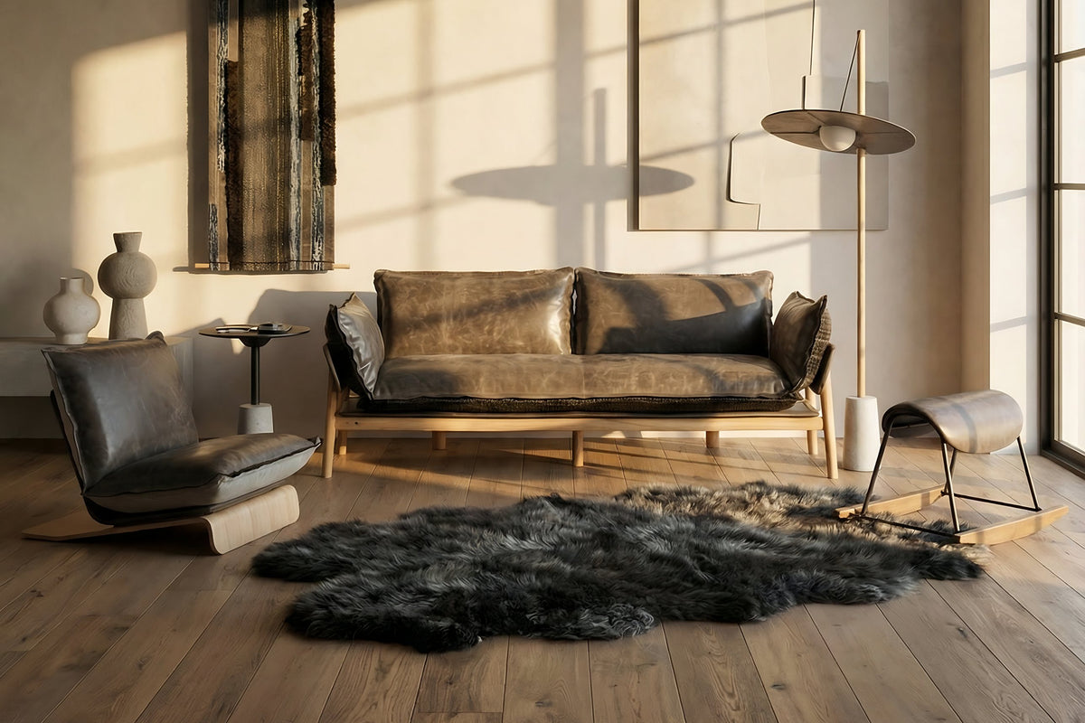 NOMAD Skin Sofa and Skin Lounge Chair in yak leather with the Drumroll floor lamp
